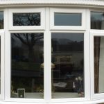 White uPVC bow windows in timber effect style