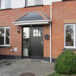 A front door with a canopy installed over to provide shelter