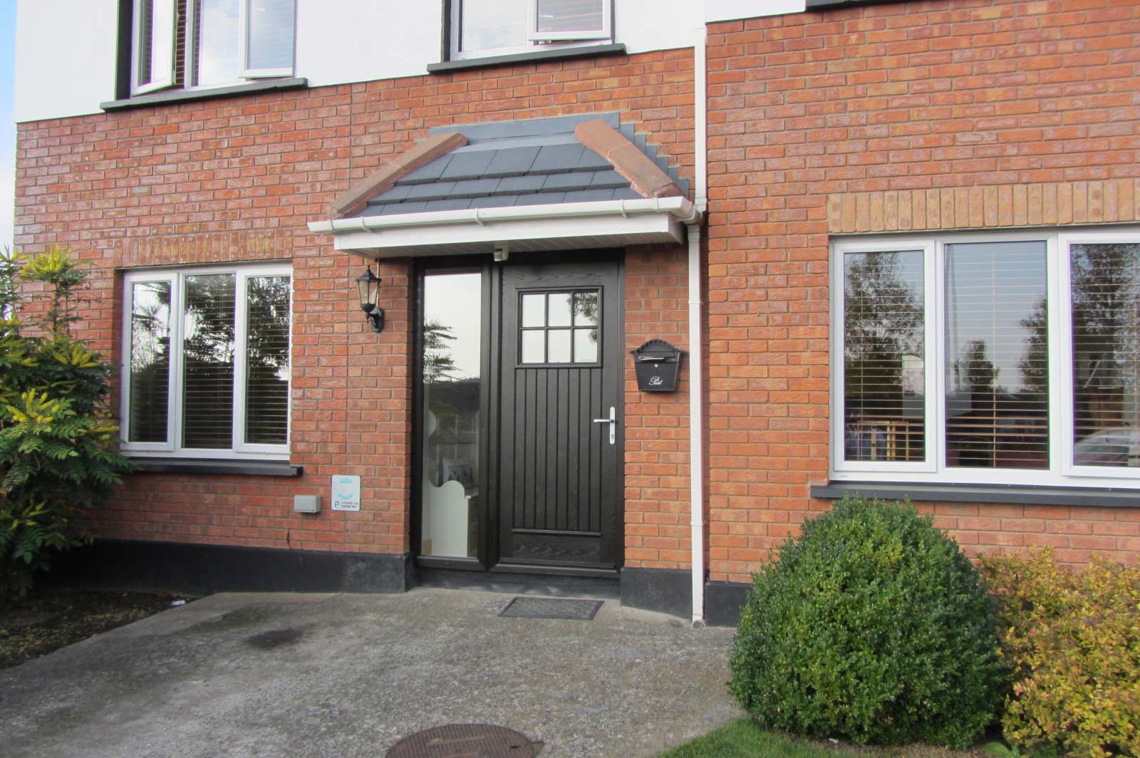 A front door with a canopy installed over to provide shelter