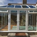 White upvc conservatory with casement windows and french doors